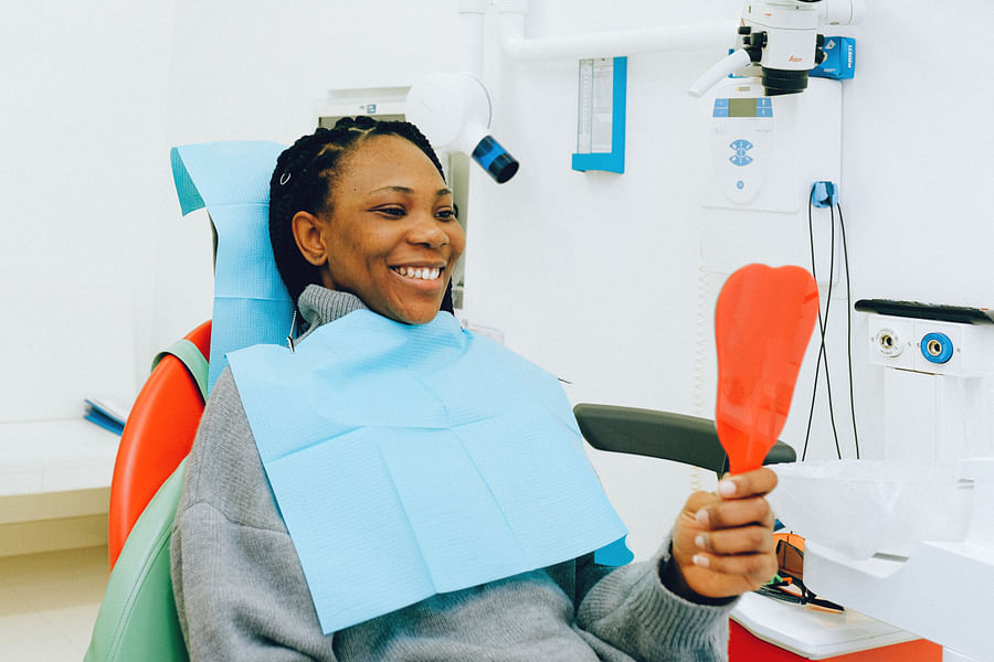 Dentist preparing patient for dental X-ray procedure
