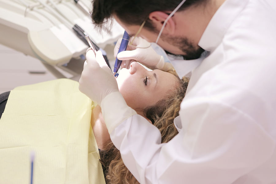 Dentist examining a patient\'s oral health